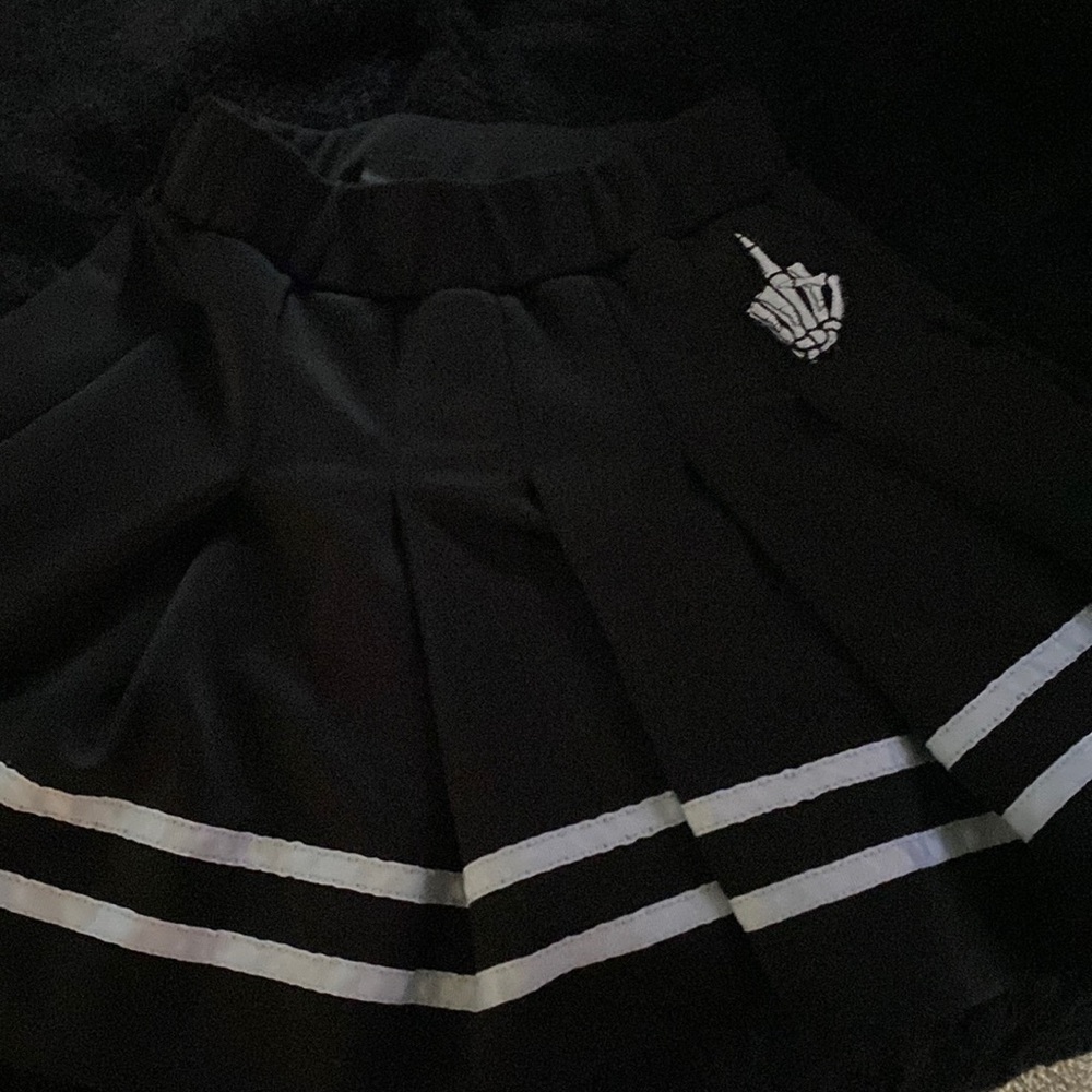 Medium sized Spencers store skirt that is black and white.